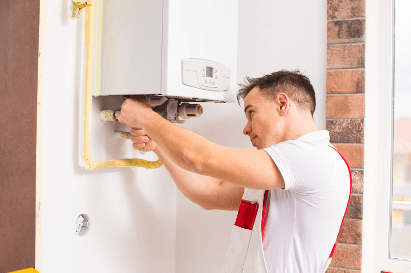 A man fixing a boiler demonstrating the benefits of maintaining heating and boiler services